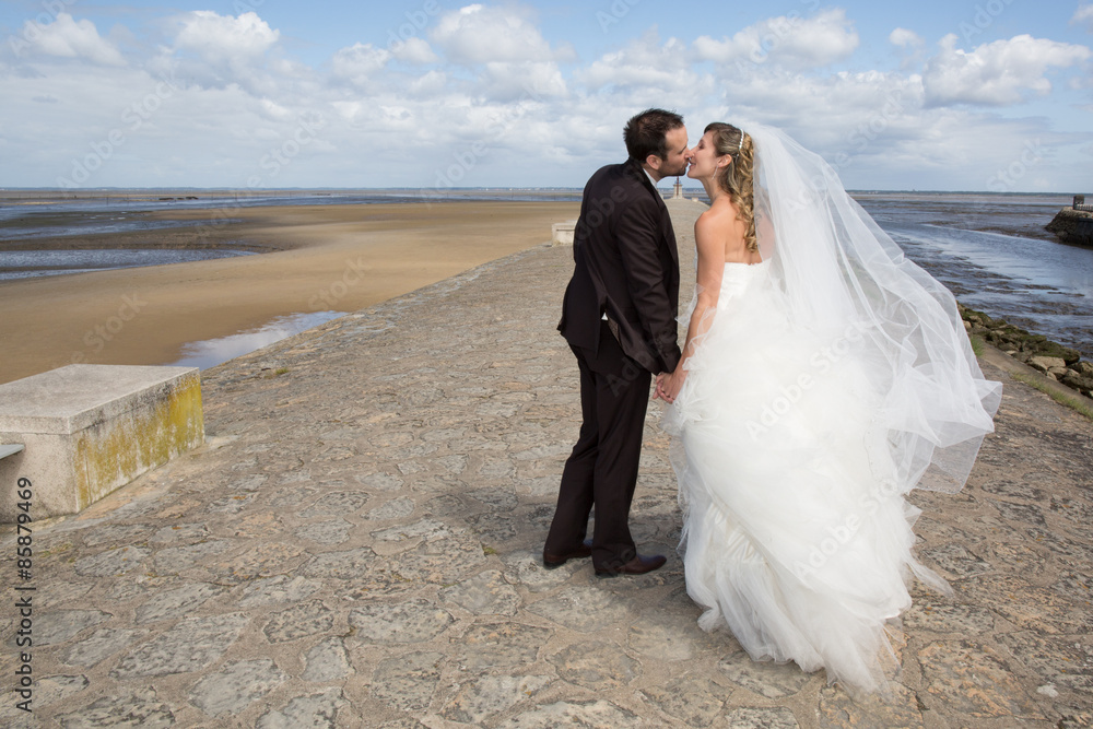 Beautiful couple on the beach in wedding dress Beautiful couple on the beach in wedding dress