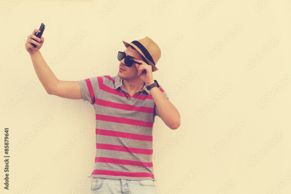 Urban guy taking a selfie outdoors. Urban guy taking a selfie outdoors.