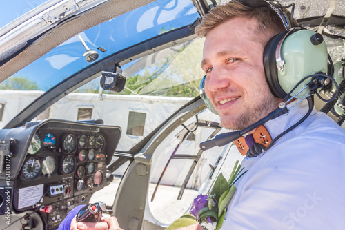 happy groom riding helicopter photo