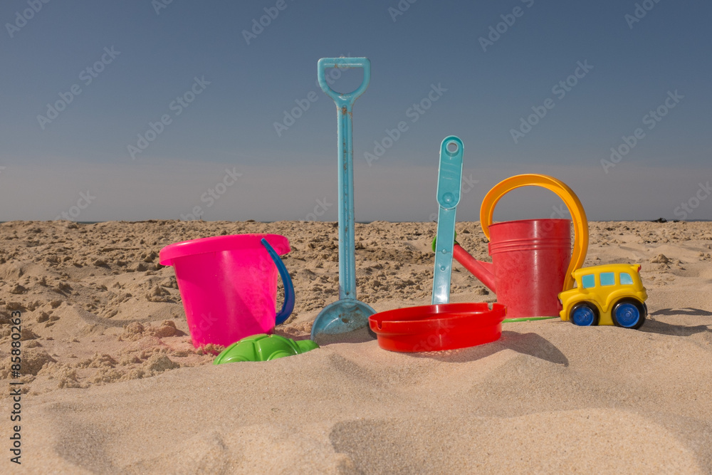 Colorful beach toys under blue sky on summertime Colorful beach toys under blue sky on summertime