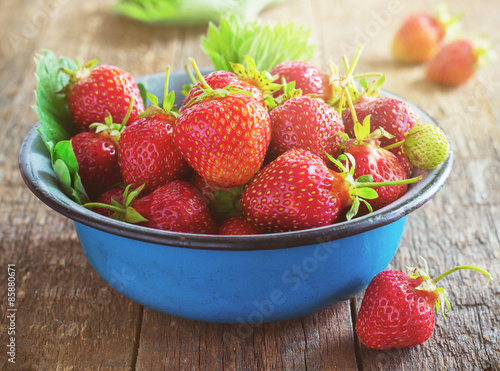 fresh juicy organic strawberries in an old metal bowl