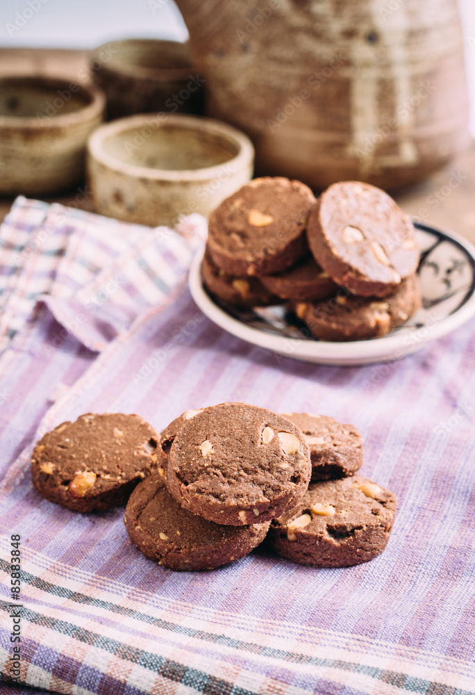 Fototapeta premium Chocolate and hazelnuts cookies on cloth