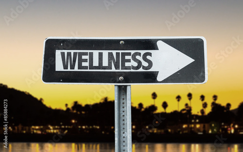 Wellness direction sign with sunset background