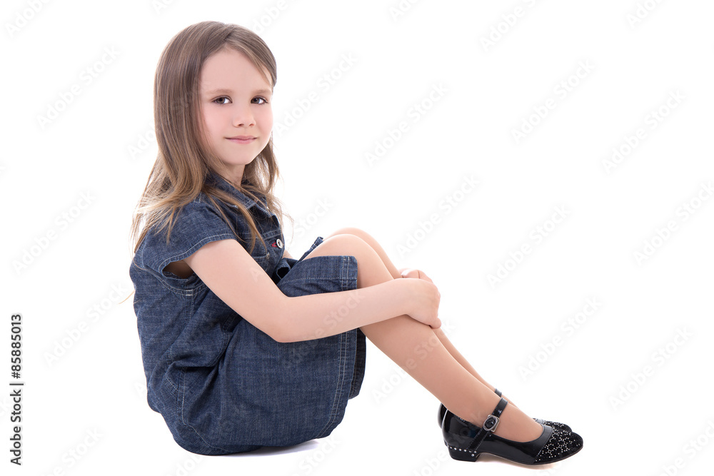 cute little girl in denim dress sitting isolated on white cute little girl in denim dress sitting isolated on white