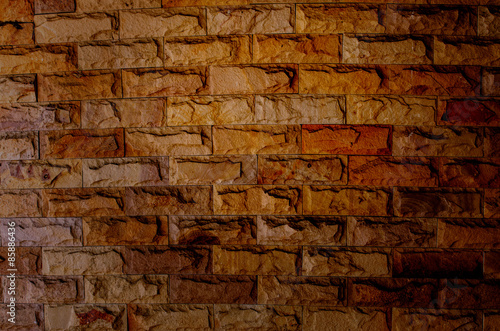 Old empty brick wall background, plaster falling off.