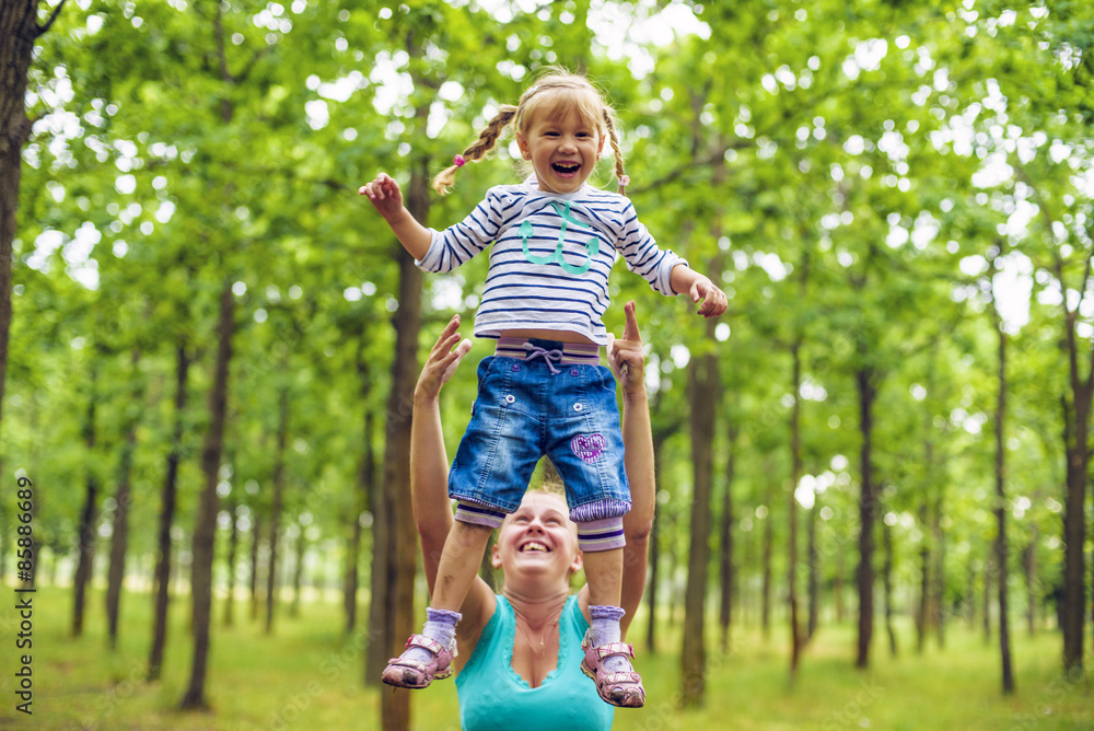 mother and daughter having fun in the park mother and daughter having fun in the park