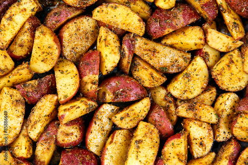 Roasted potatoes with rosemary and spices. Ready to cook Background, texture.