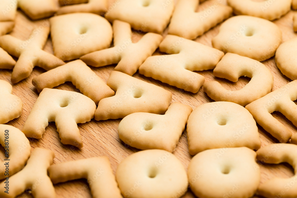 Baked letter cookie over the wooden table Baked letter cookie over the wooden table