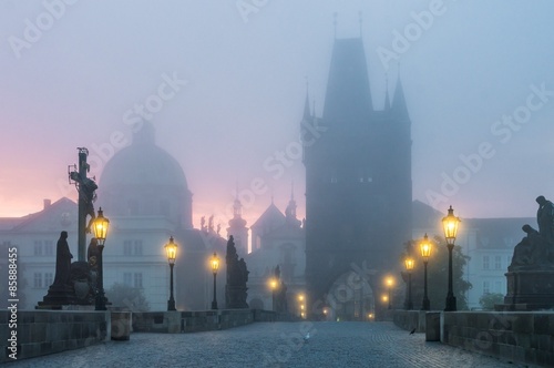 Charles Bridge in Prague at sunrise at morning in fog © vchalup