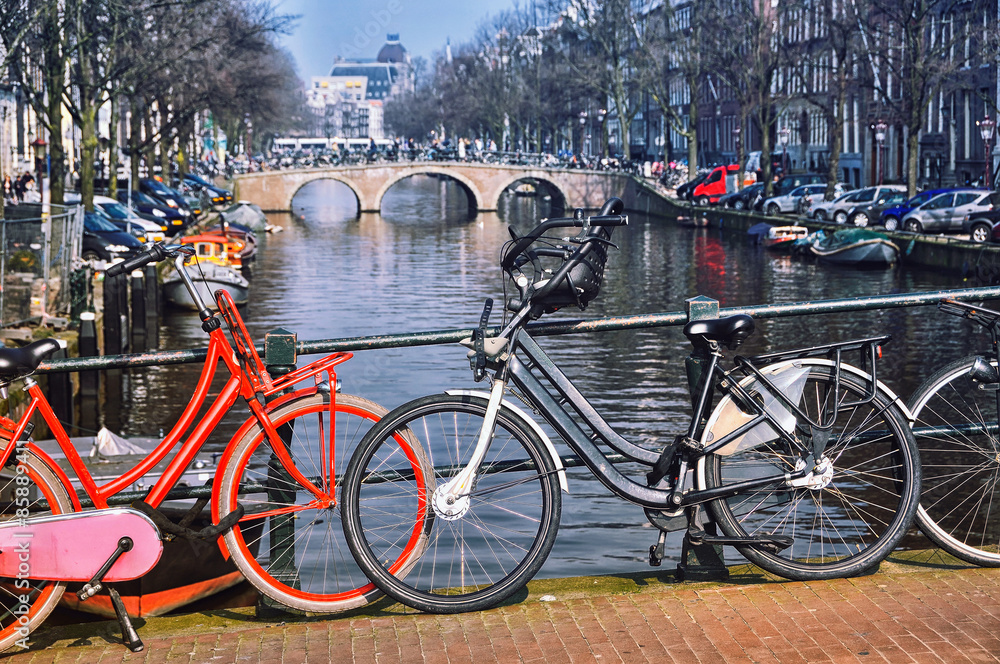 Typical city bicycles in Amsterdam at the bridge
