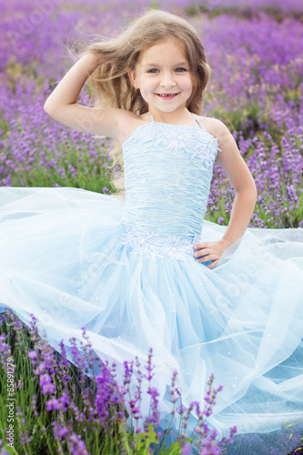 Happy cute girl in a field of lavender, summer