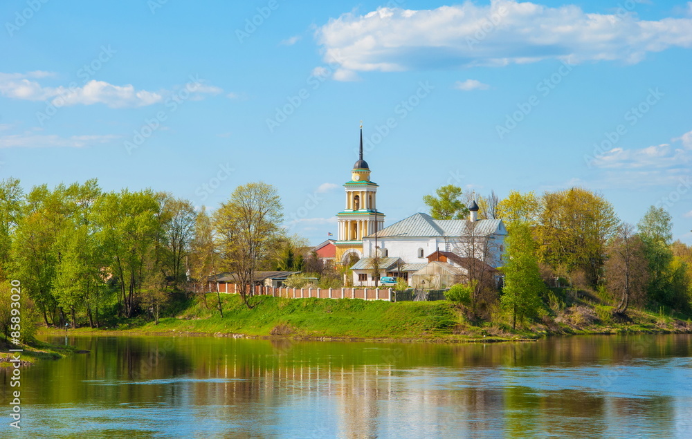 Summer landscape with a church on the river