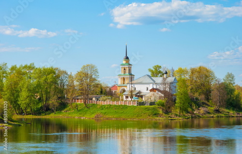 Summer landscape with a church on the river
