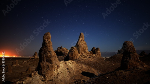  astrophotography time lapse with pan right motion of night to day transition over eroded formation in Trona Pinnacles, California