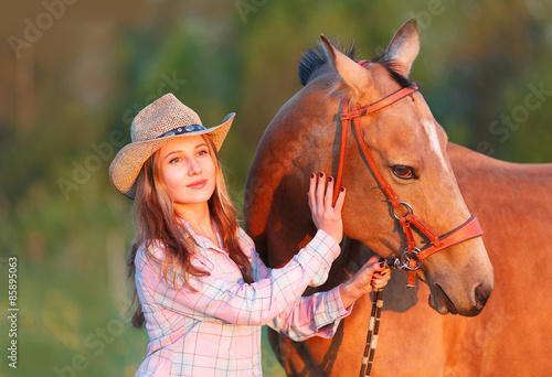 Girl in a hat with a horse 