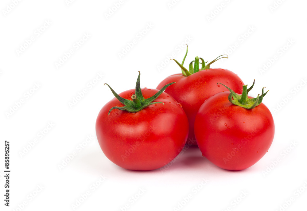 Fresh tomatoes with green leaves isolated on white background Fresh tomatoes with green leaves isolated on white background
