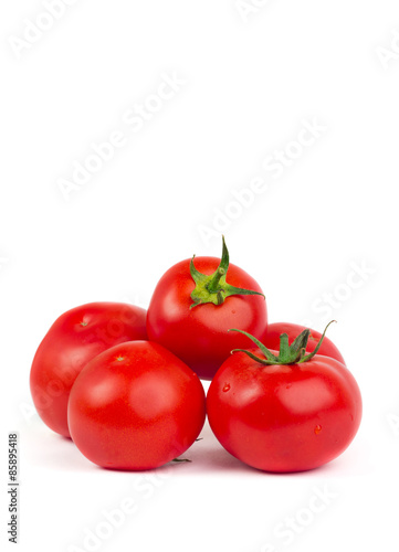 Fresh tomatoes with green leaves isolated on white background