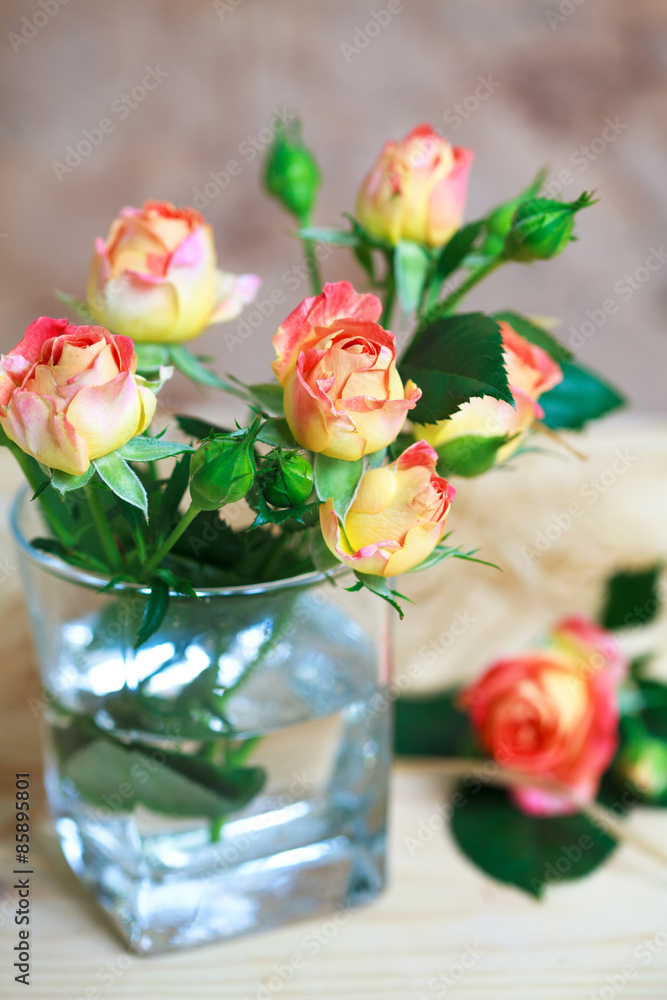 beautiful bouquet of roses in glass on wooden table beautiful bouquet of roses in glass on wooden table