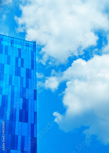 Modern high rise building against the sky clouds