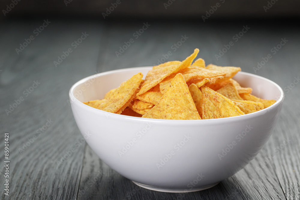 tortilla chips in white bowl on wooden table tortilla chips in white bowl on wooden table