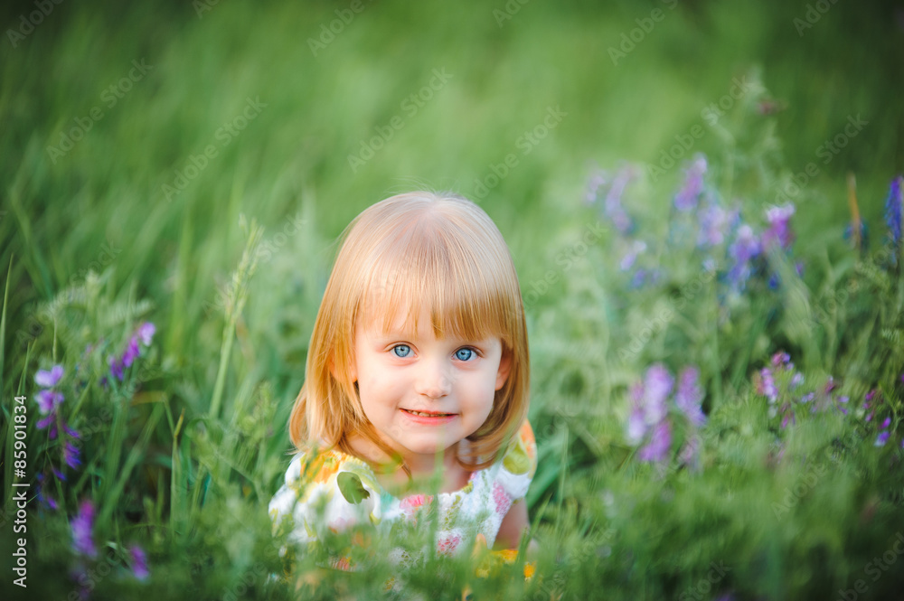 Cute cheerful blond girl playing in the park Cute cheerful blond girl playing in the park