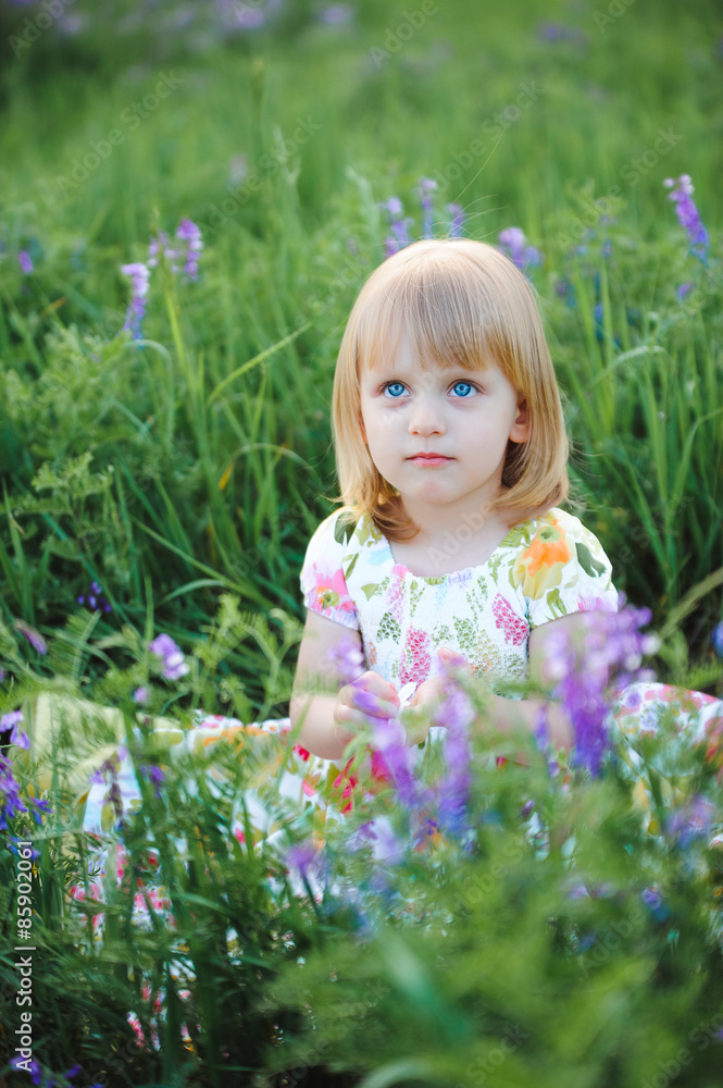 Cute cheerful blond girl playing in the park Cute cheerful blond girl playing in the park