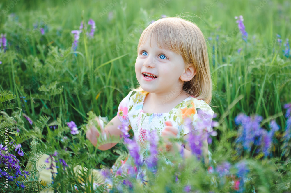 Cute cheerful blond girl playing in the park Cute cheerful blond girl playing in the park