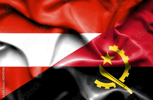 Waving flag of Angola and Austria