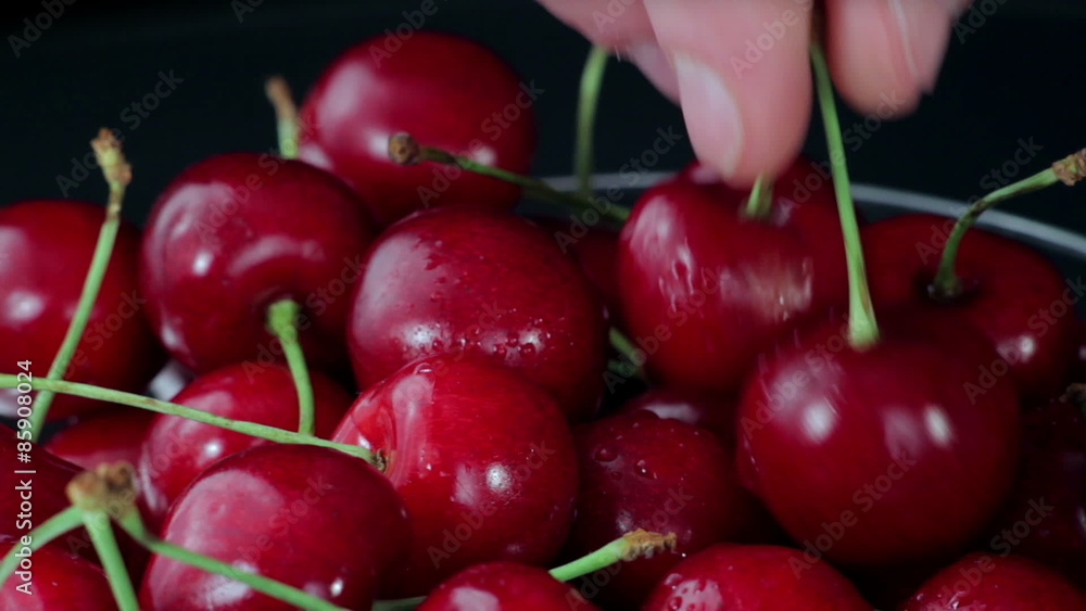 A Group of of Ripe Red Cherries Taken from a Beautiful Dish. Close up A Group of of Ripe Red Cherries Taken from a Beautiful Dish. Close up