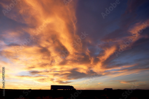 Freight Truck on Highway under dramatic sunset sky