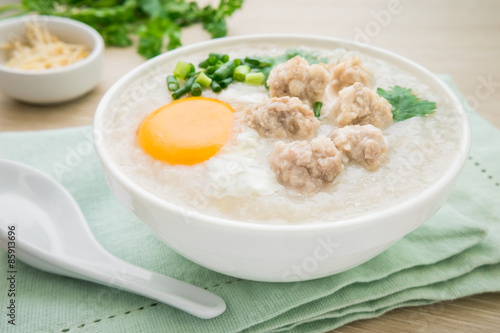 Congee with minced pork and boiled egg in bowl photo
