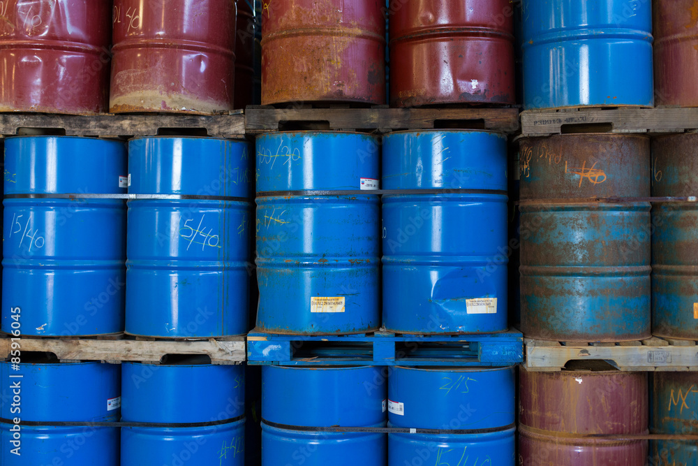 Rows of stacked steel barrels of various colors Rows of stacked steel barrels of various colors