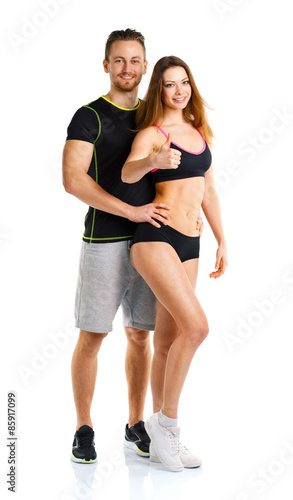 Athletic man and woman after fitness exercise with a thumb up on