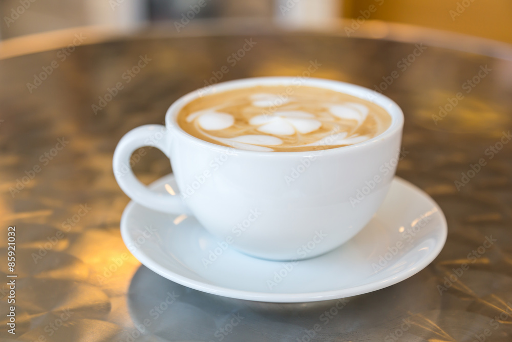 Cup of coffee with heart pattern in a white cup on Cup of coffee with heart pattern in a white cup on