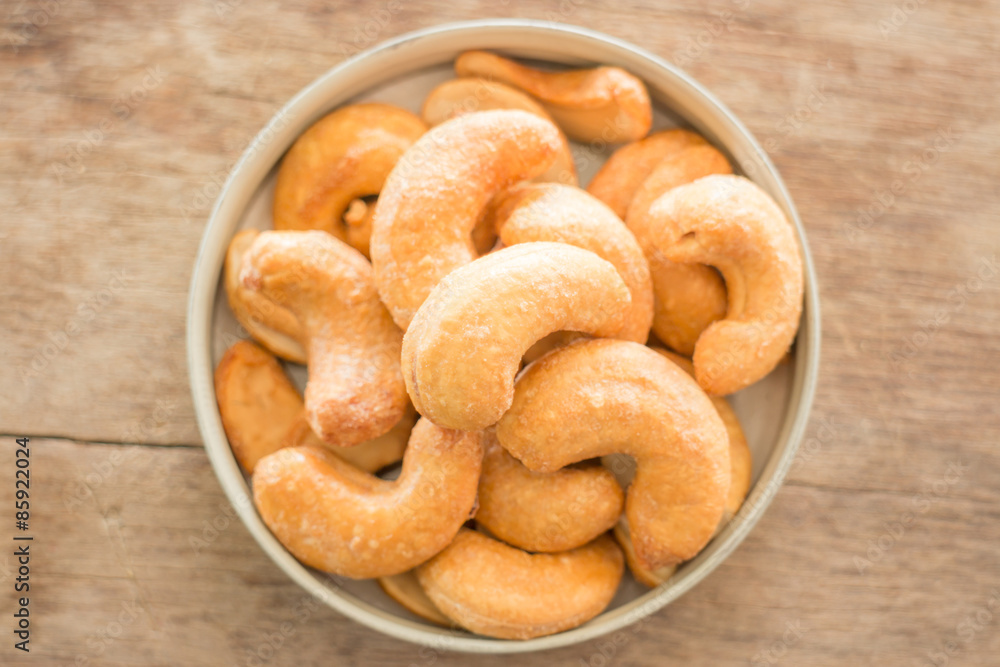 Cashew nut roast salt on weathered wooden table Cashew nut roast salt on weathered wooden table