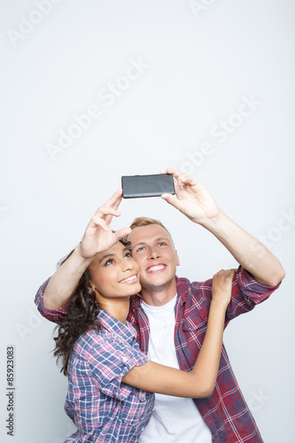 Happy couple making photos