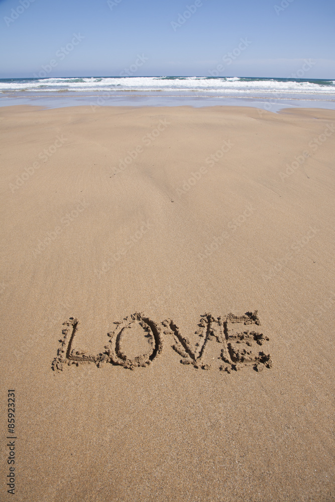 Fototapeta premium love text in sand beach