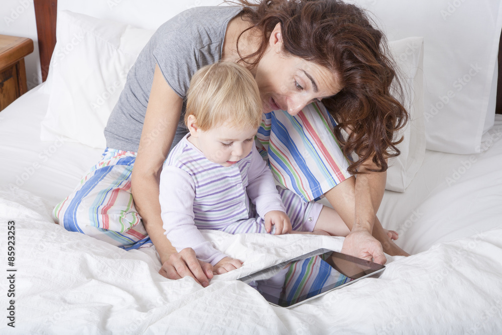 mother baby and tablet in bed mother baby and tablet in bed