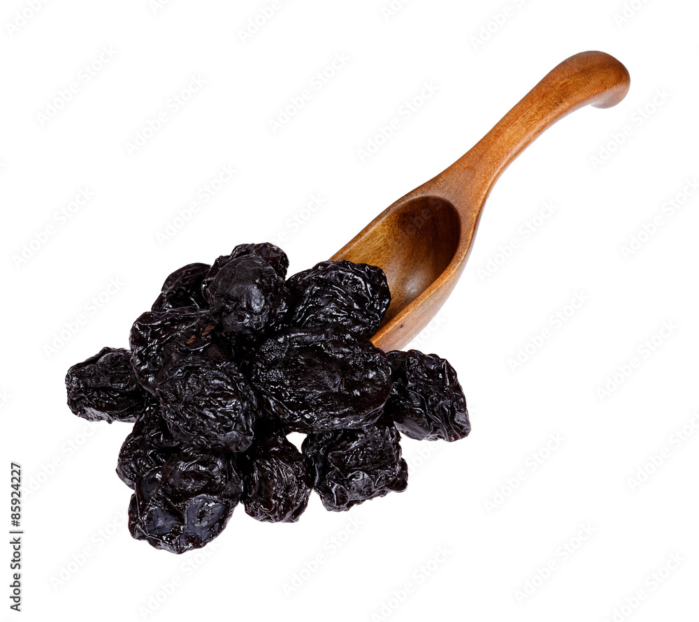 Dried Prunes in the wooden spoon, isolated on white background. Dried Prunes in the wooden spoon, isolated on white background.