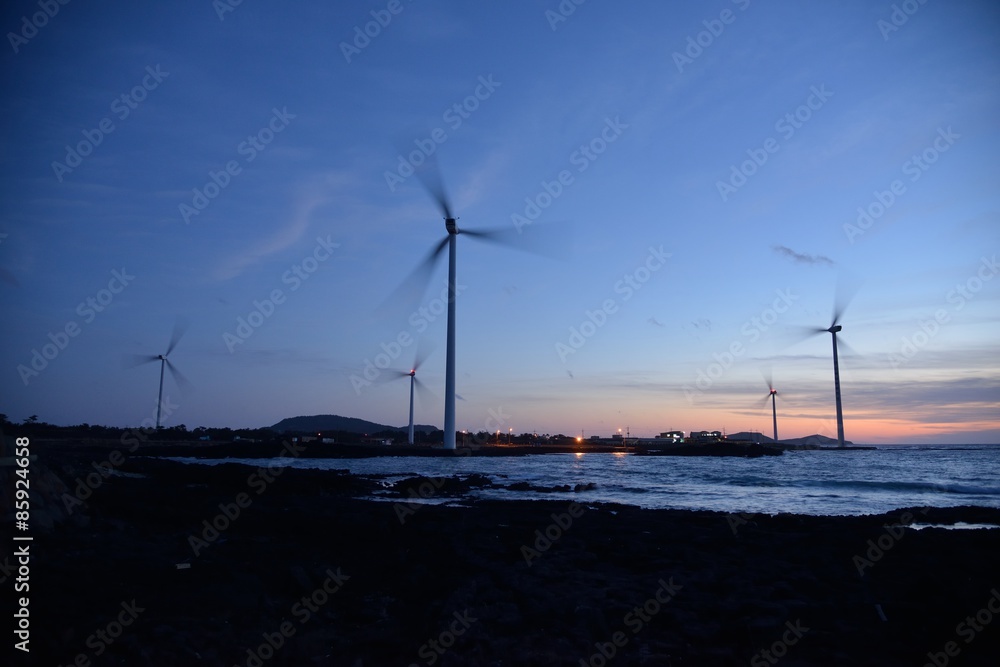 Eletric Power Generator Wind Turbine over a Cloudy Sky in Jeju C
