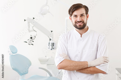 Fényképezés Portrait of young handsome dentist in clinic