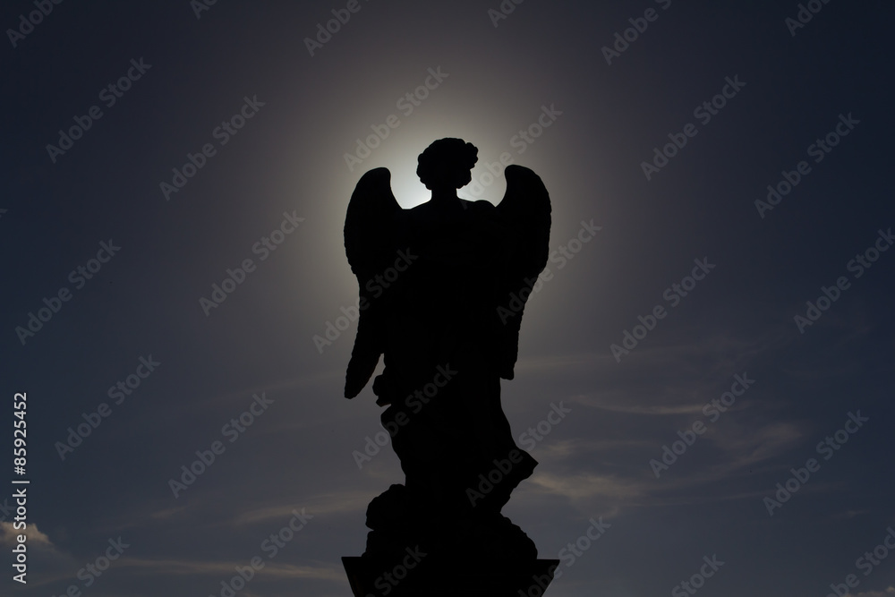 Silhouette of a statue of an angel outside Saint Angelo Castel