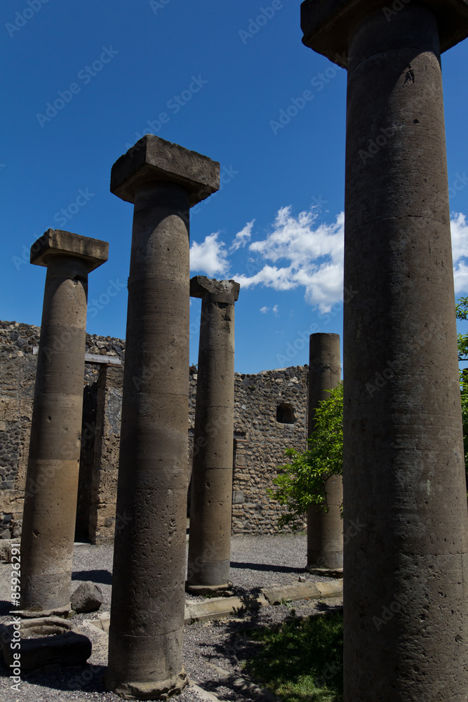 Restored stone columns adorning a courtyard in Pompeii Restored stone columns adorning a courtyard in Pompeii