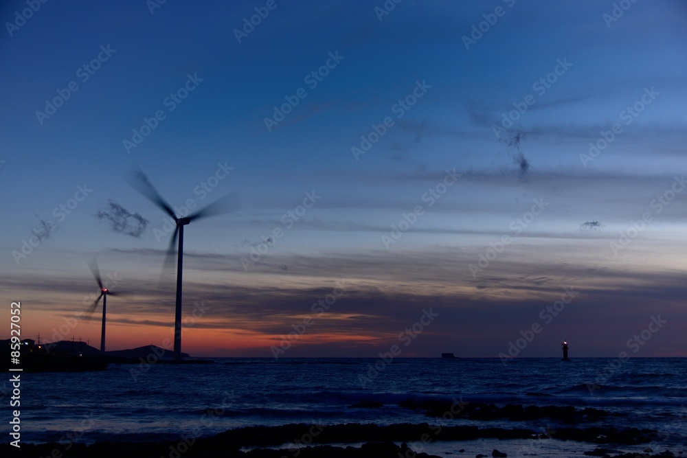 Eletric Power Generator Wind Turbine over a Cloudy Sky in Jeju C