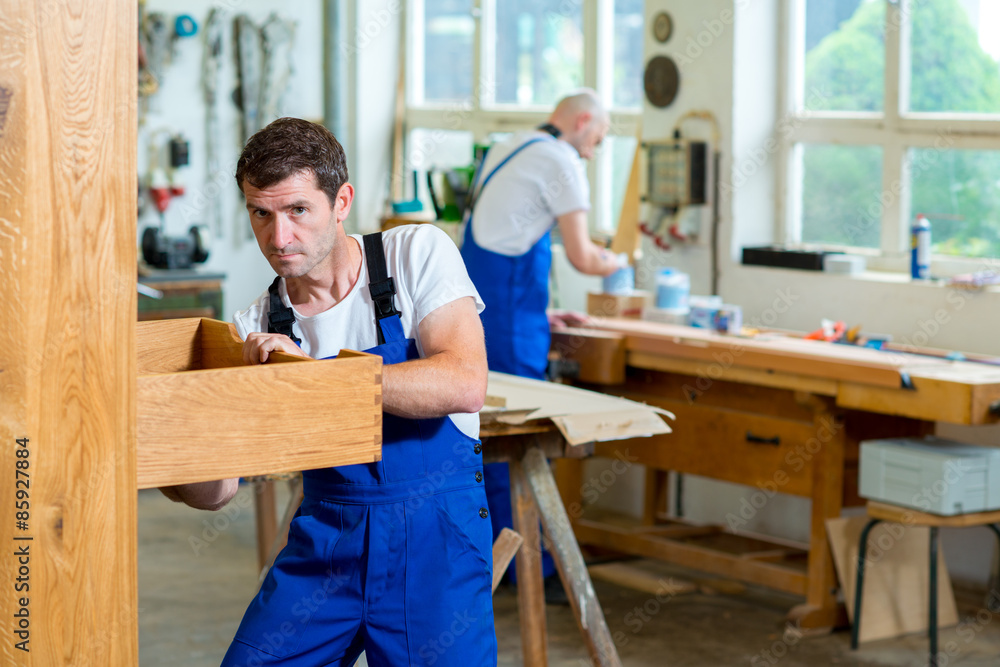 two worker in a carpenter's workshop two worker in a carpenter's workshop