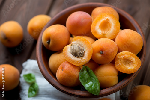 Ripe apricots in a ceramic bowl, close-up, selective focus