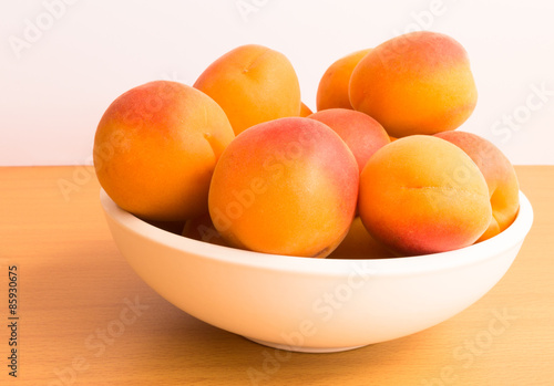Bowl of Fresh Apricots on Wooden Table Top