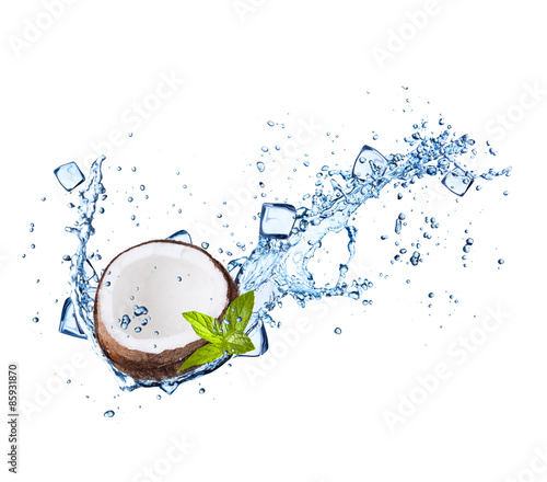 Coconut with water splashes on white