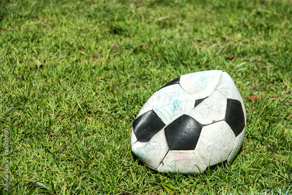 Deflated soccer ball on grass. Soccer concept. Stock-Foto | Adobe Stock