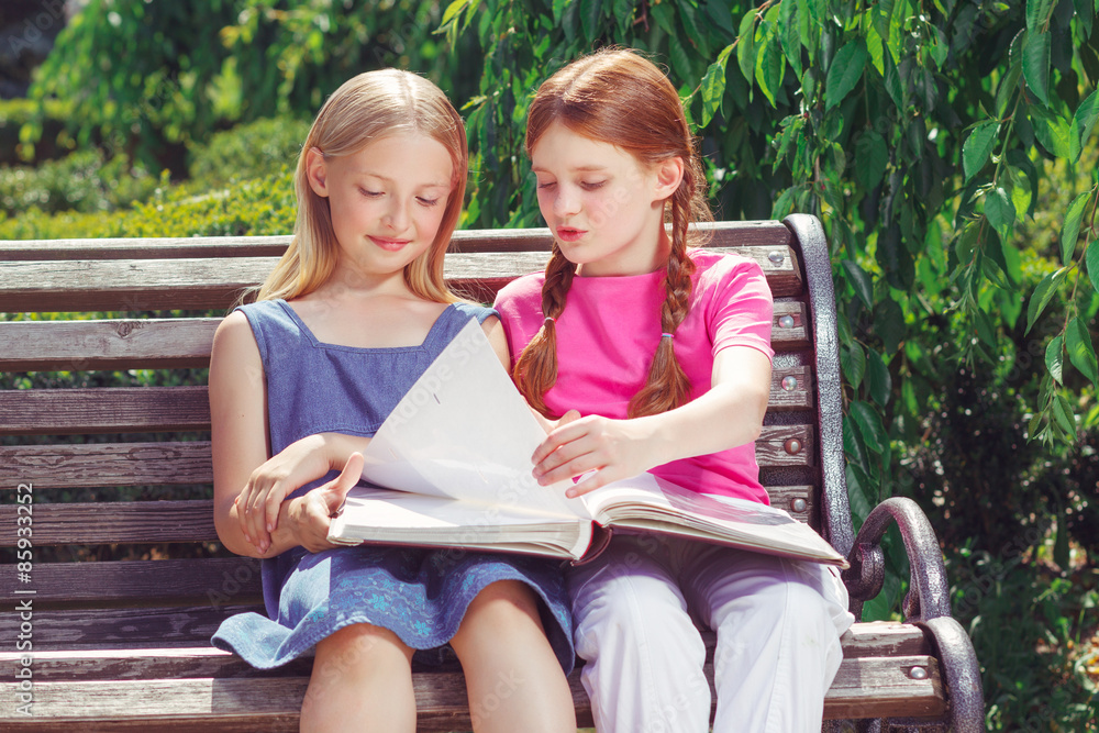 Nice smiling children sitting on the bench Nice smiling children sitting on the bench